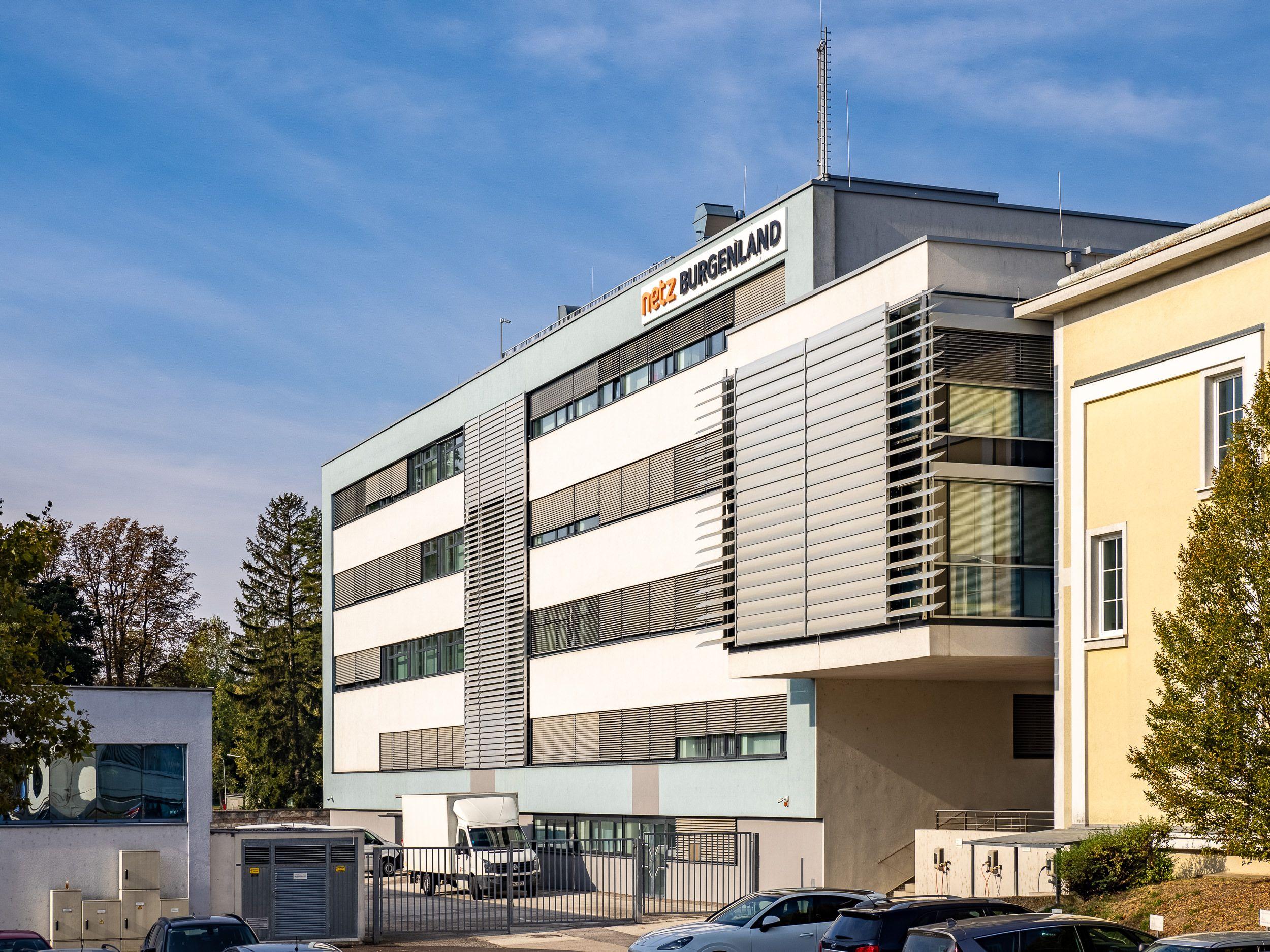 Moderne Architektur des Netz Burgenland Bürogebäudes mit Firmenschild.